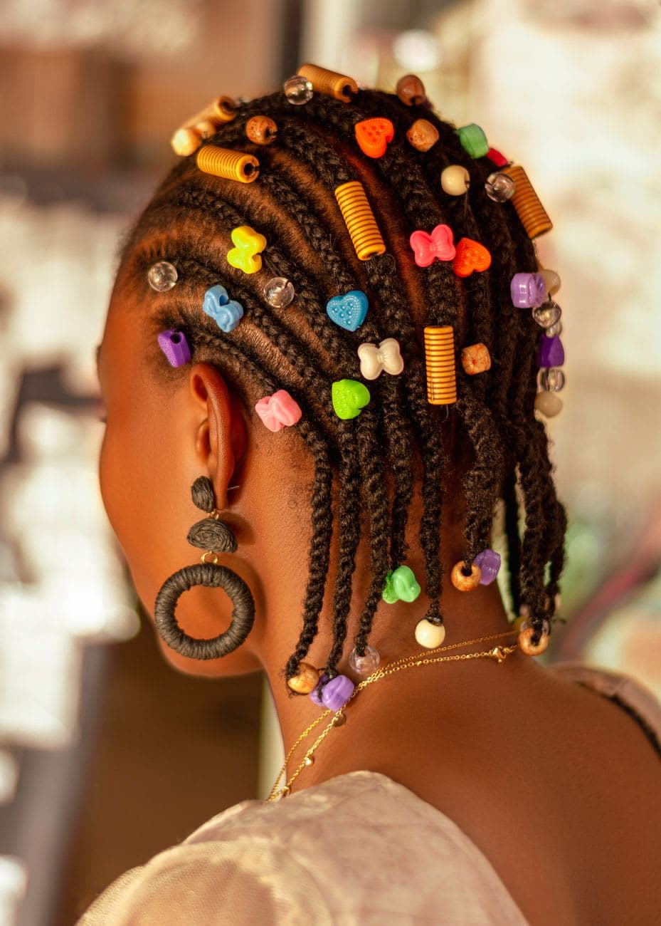 Close-up of an African woman's colorful beaded hairstyle, highlighting traditional beauty in Ado Ekiti.